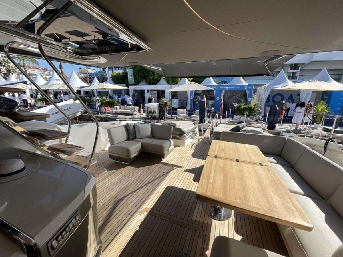 a room with a table chairs and people in it aboard PRINCESS S78 Yacht for Sale