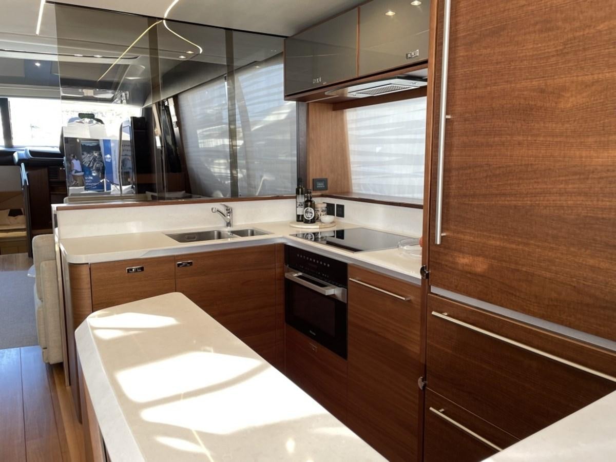a kitchen with wooden cabinets aboard PRINCESS S78 Yacht for Sale