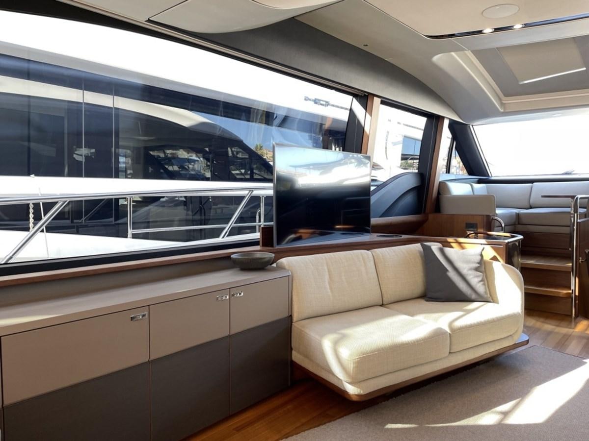 a room with a couch and a large window aboard PRINCESS S78 Yacht for Sale