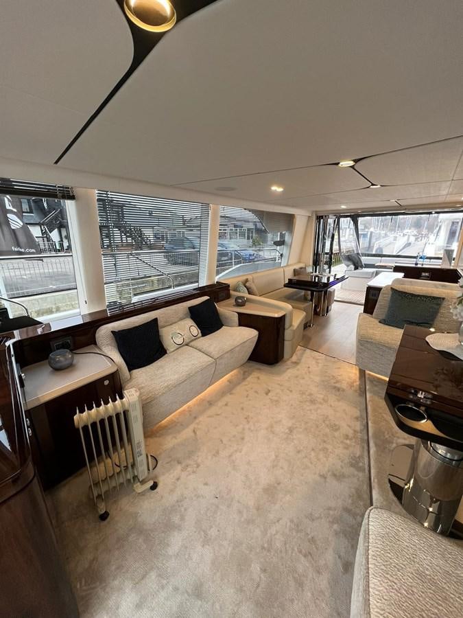 a living room with a large window aboard SQUADRON 68 Yacht for Sale
