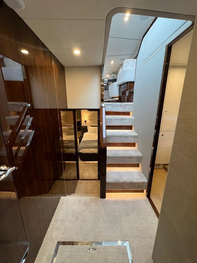 a set of stairs leading to a room with a person sitting at the bottom aboard SQUADRON 68 Yacht for Sale