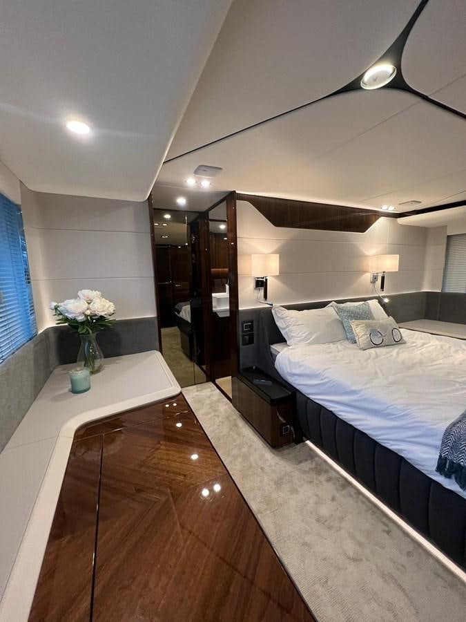 a bedroom with a bed and a desk aboard SQUADRON 68 Yacht for Sale