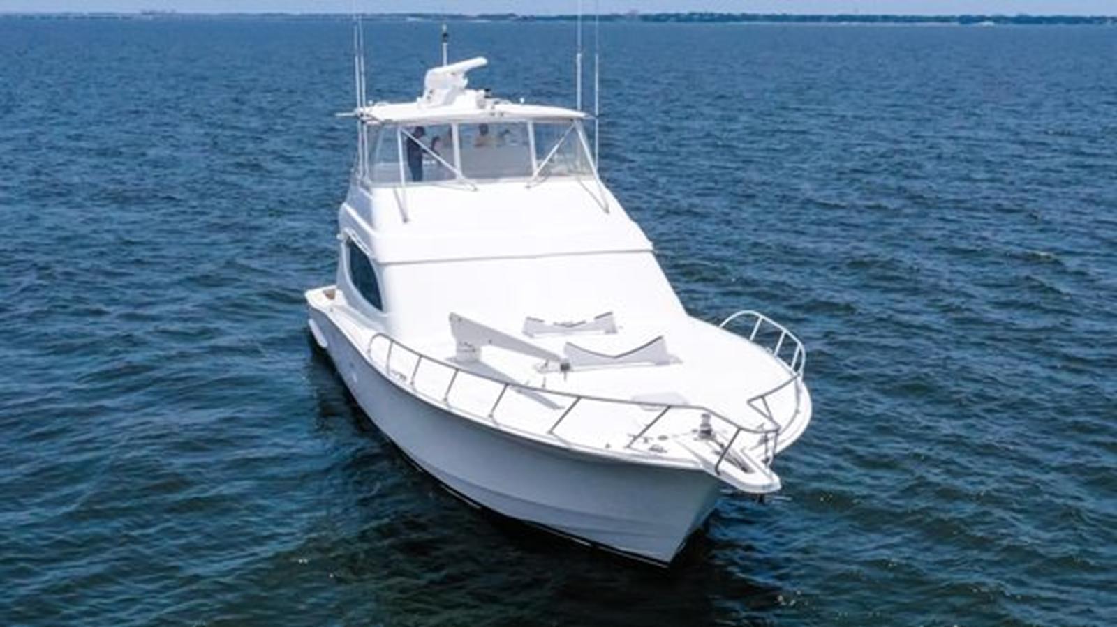 a white boat in the water aboard 2007 68 HATTERAS CONVERTIBLE Yacht for Sale