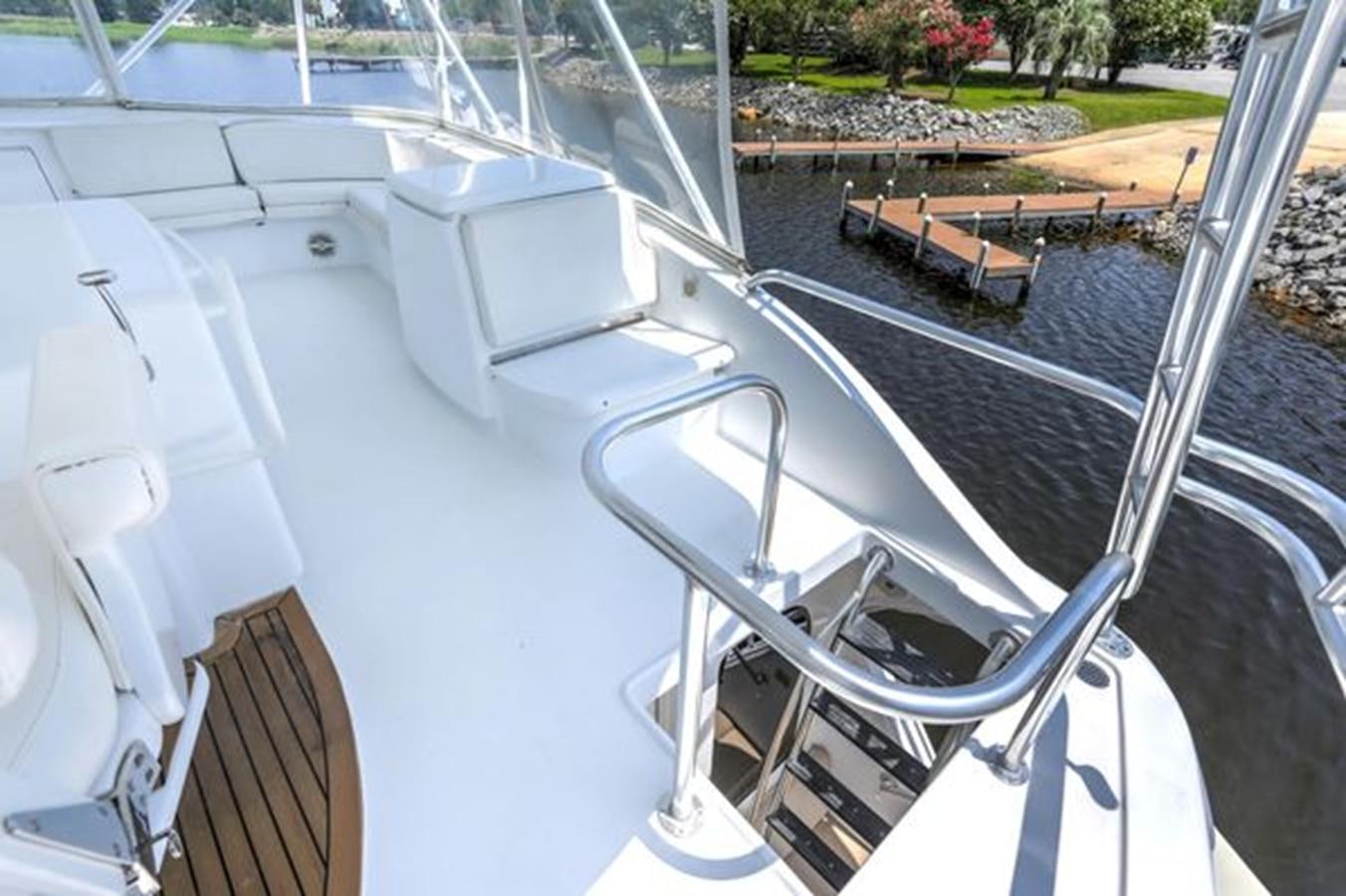 a white boat on a deck aboard 2007 68 HATTERAS CONVERTIBLE Yacht for Sale