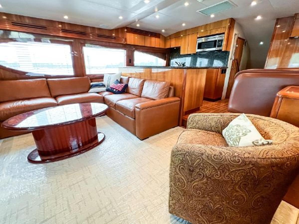 a living room with leather couches aboard 2007 68 HATTERAS CONVERTIBLE Yacht for Sale
