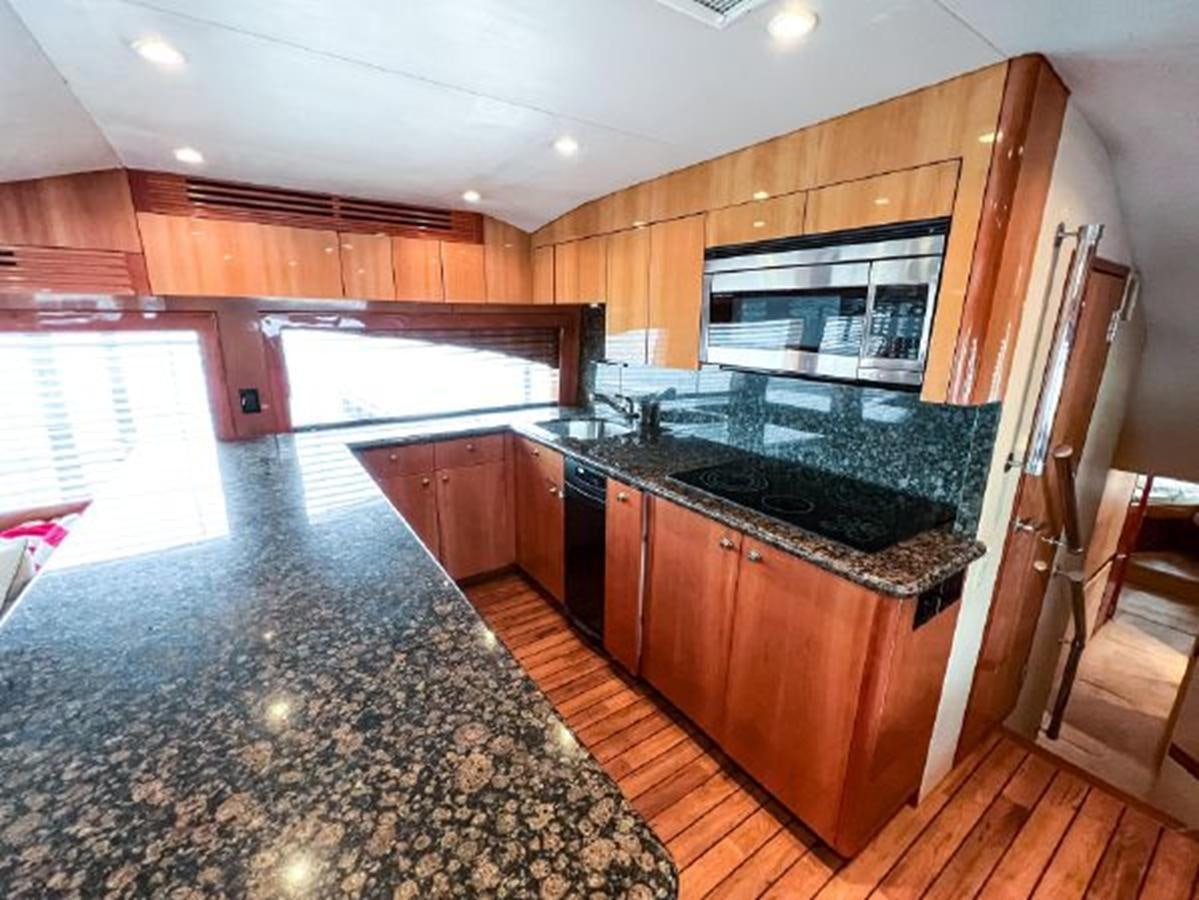 a kitchen with a marble counter top aboard 2007 68 HATTERAS CONVERTIBLE Yacht for Sale