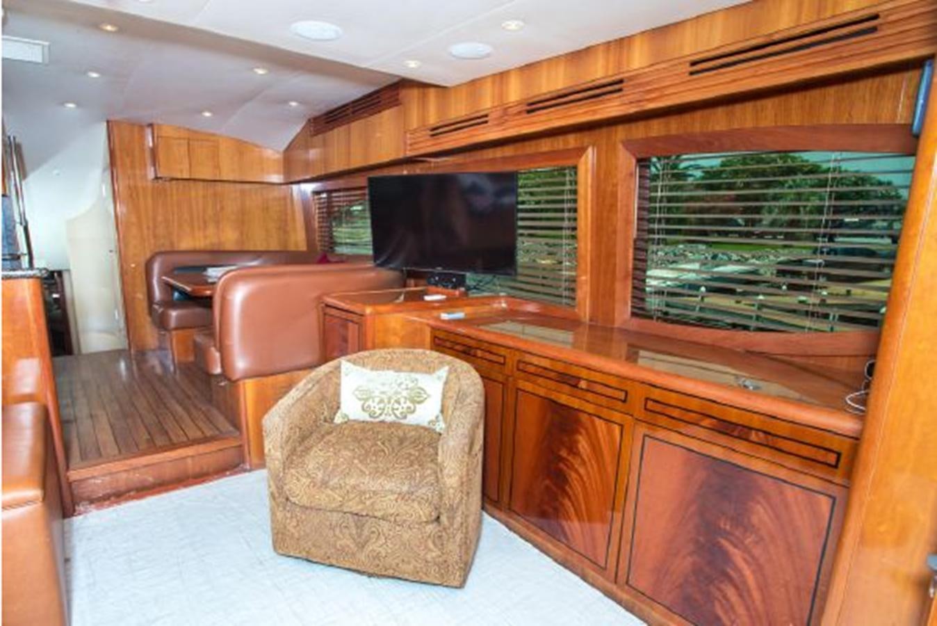 a room with a tv and a couch aboard 2007 68 HATTERAS CONVERTIBLE Yacht for Sale