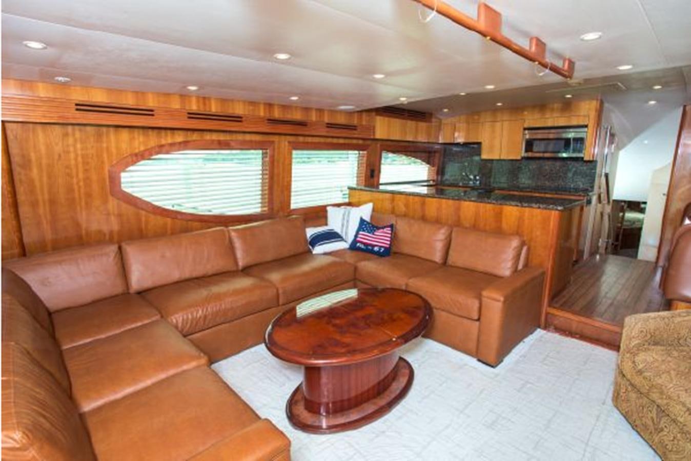 a living room with brown couches aboard 2007 68 HATTERAS CONVERTIBLE Yacht for Sale