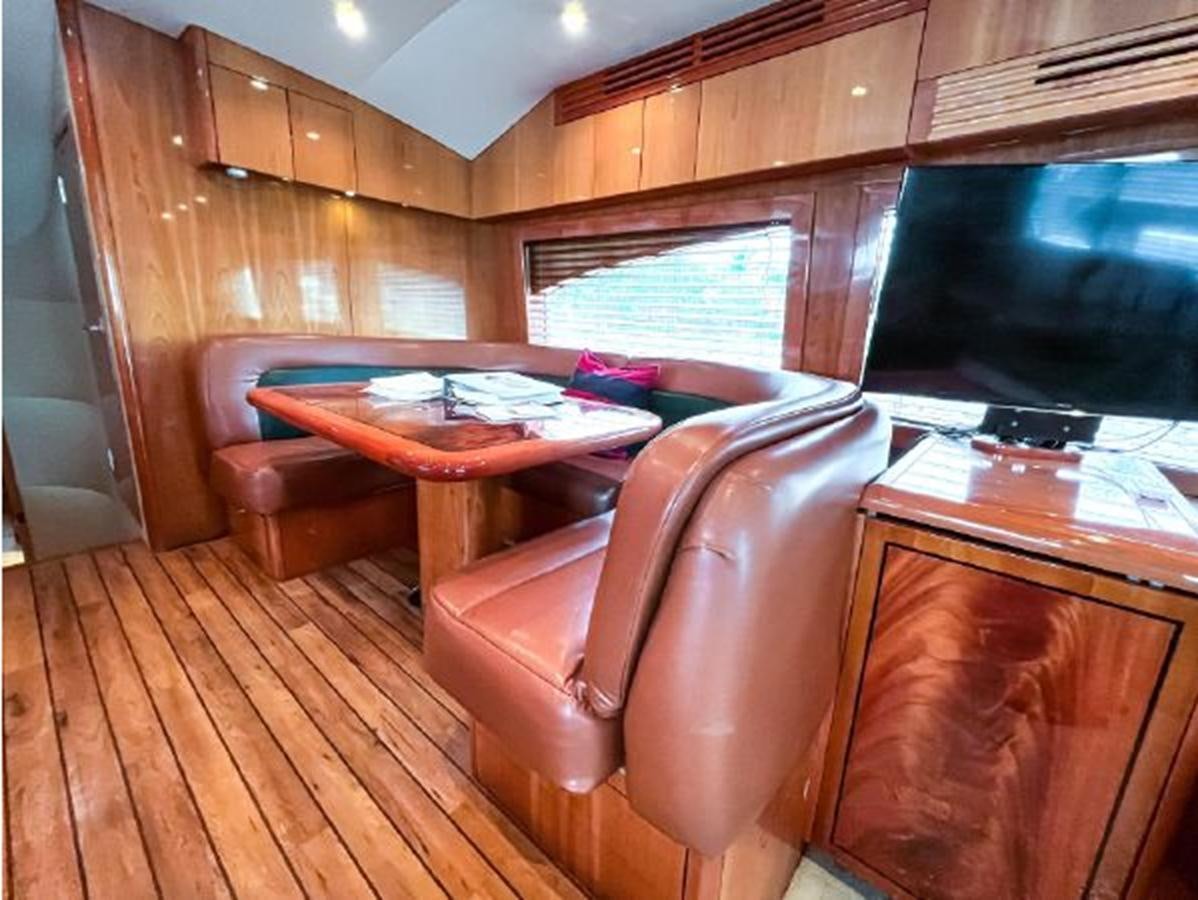 a living room with a couch and a table aboard 2007 68 HATTERAS CONVERTIBLE Yacht for Sale