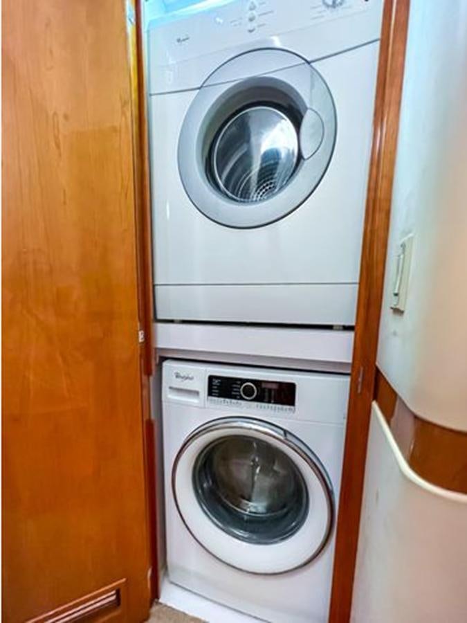 a washing machine in a closet aboard 2007 68 HATTERAS CONVERTIBLE Yacht for Sale