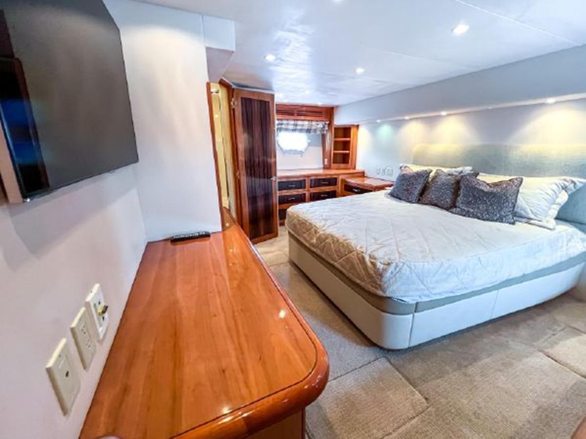 a bedroom with a bed aboard 2007 68 HATTERAS CONVERTIBLE Yacht for Sale
