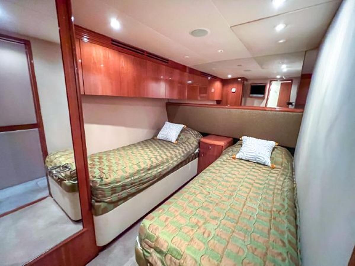 a couple of beds in a room aboard 2007 68 HATTERAS CONVERTIBLE Yacht for Sale