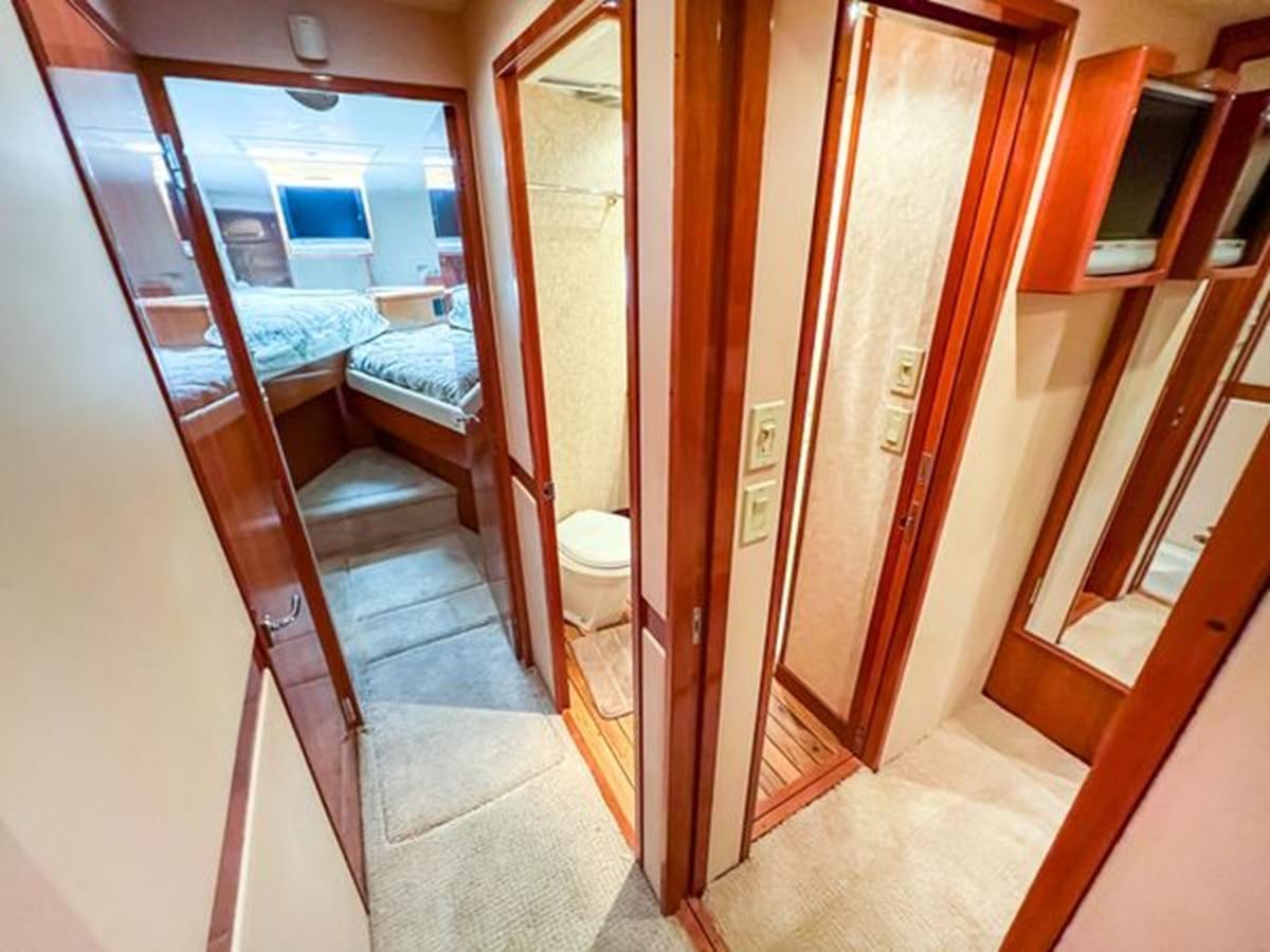 a bathroom with a bed and a closet aboard 2007 68 HATTERAS CONVERTIBLE Yacht for Sale