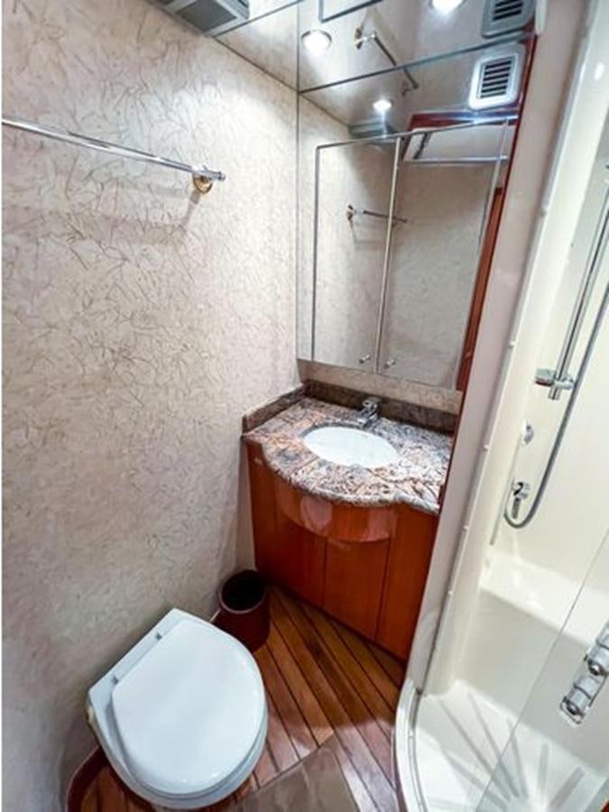 a bathroom with a sink and toilet aboard 2007 68 HATTERAS CONVERTIBLE Yacht for Sale