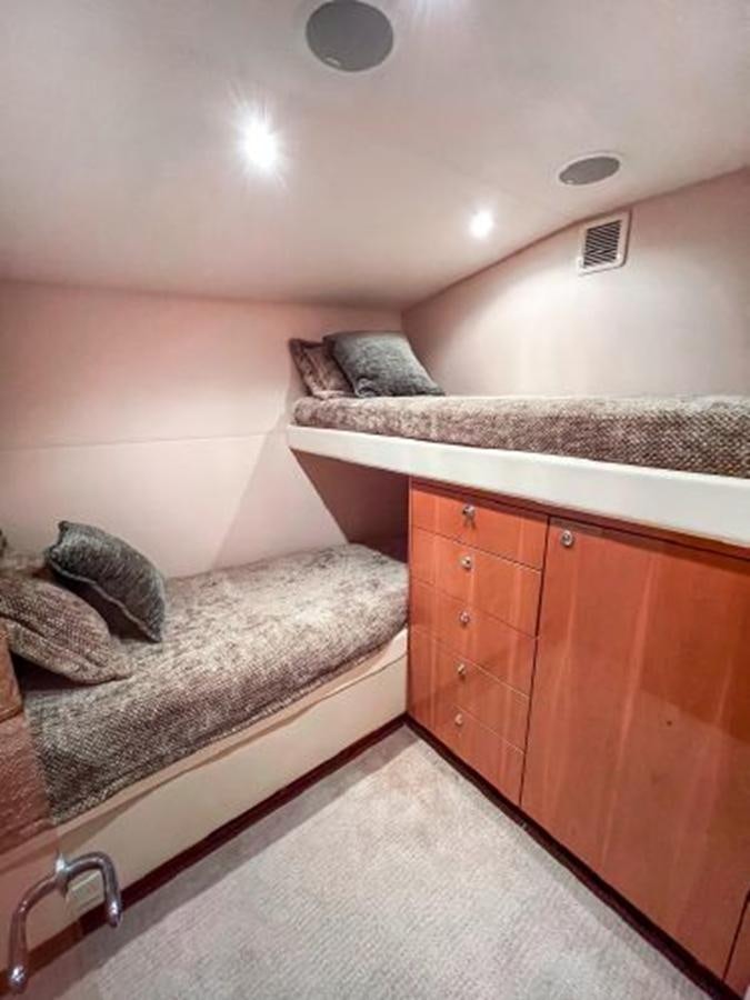 a bed in a room aboard 2007 68 HATTERAS CONVERTIBLE Yacht for Sale
