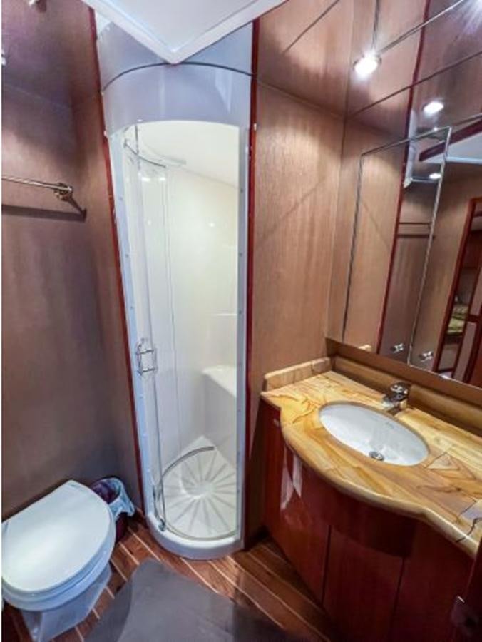 a bathroom with a sink and a toilet aboard 2007 68 HATTERAS CONVERTIBLE Yacht for Sale