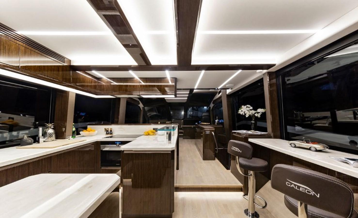 a room with a desk and chairs aboard GALEON 640 Yacht for Sale