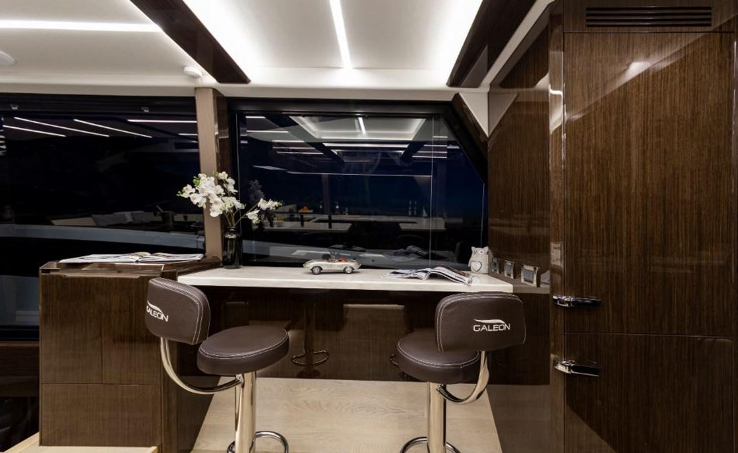 a room with a desk and chairs aboard GALEON 640 Yacht for Sale