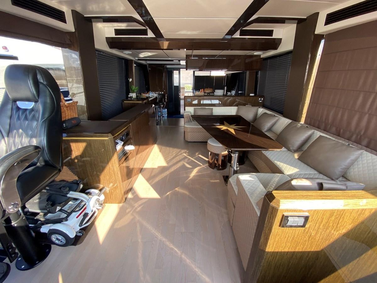 a room with a bench and a table aboard GALEON 640 Yacht for Sale