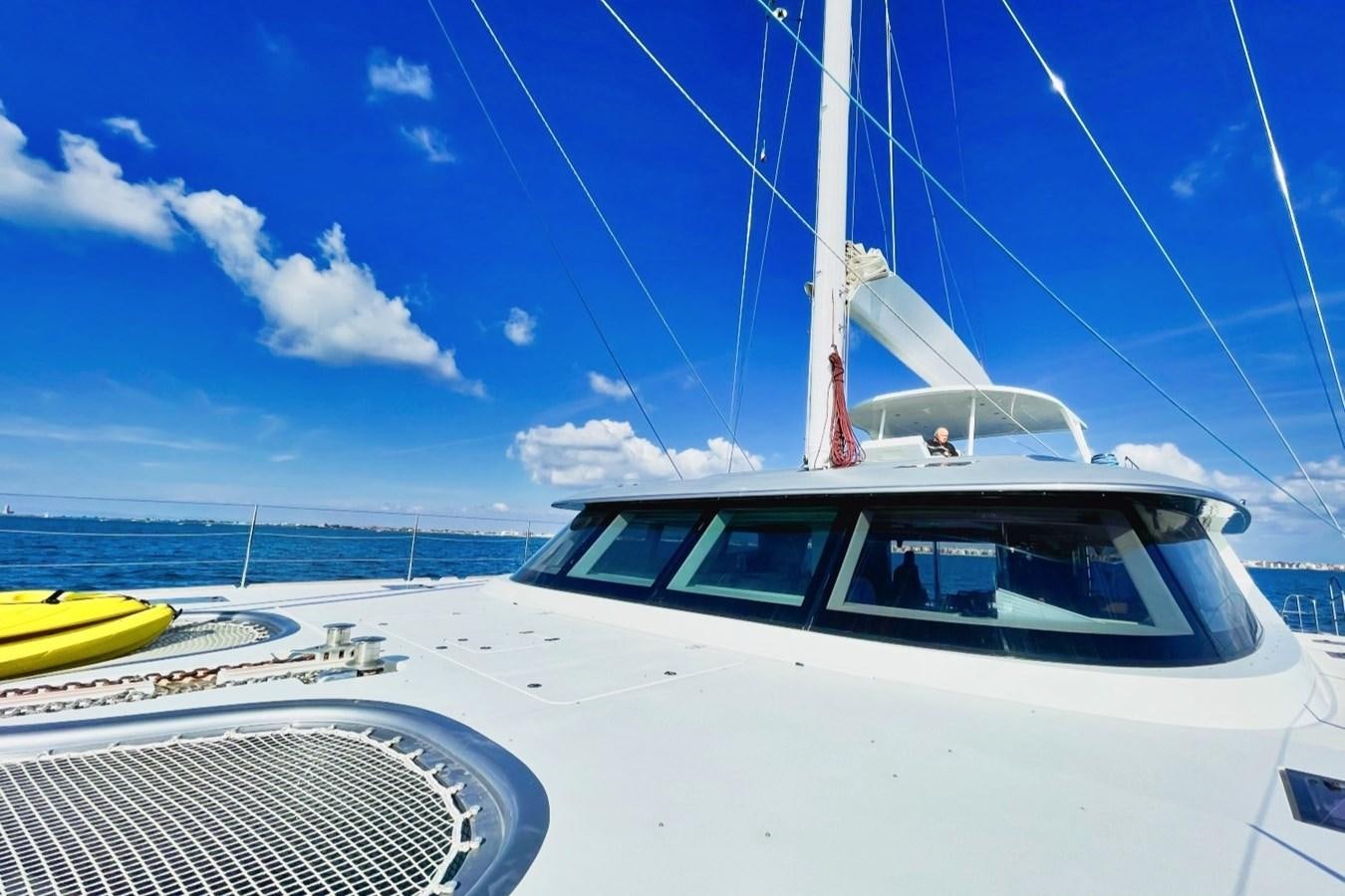 a white boat on a beach aboard ALKIMIA Yacht for Sale