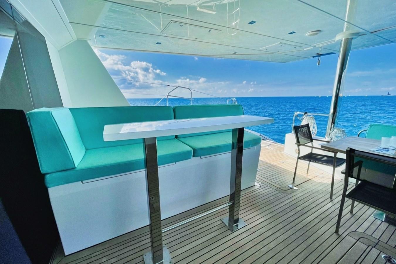 a table and chairs on a deck aboard ALKIMIA Yacht for Sale