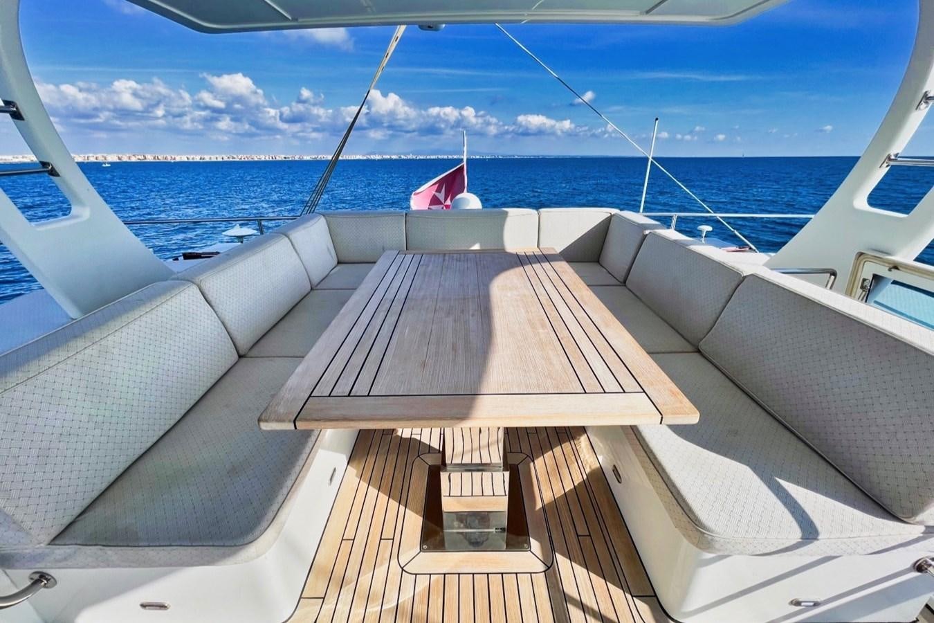 a deck with a view of the ocean and a beach aboard ALKIMIA Yacht for Sale