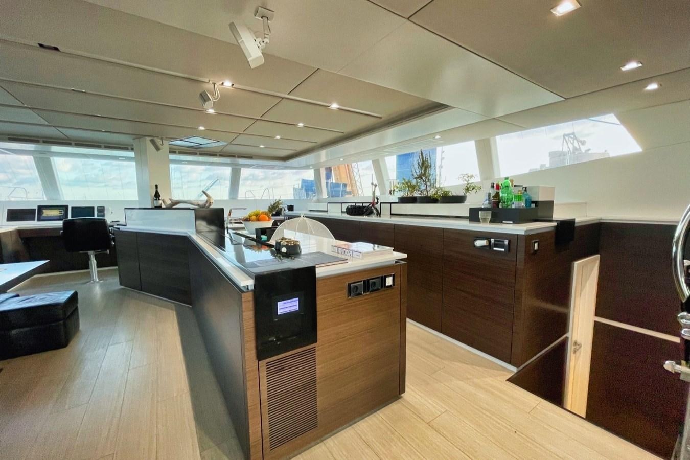 a large kitchen with a large window aboard ALKIMIA Yacht for Sale