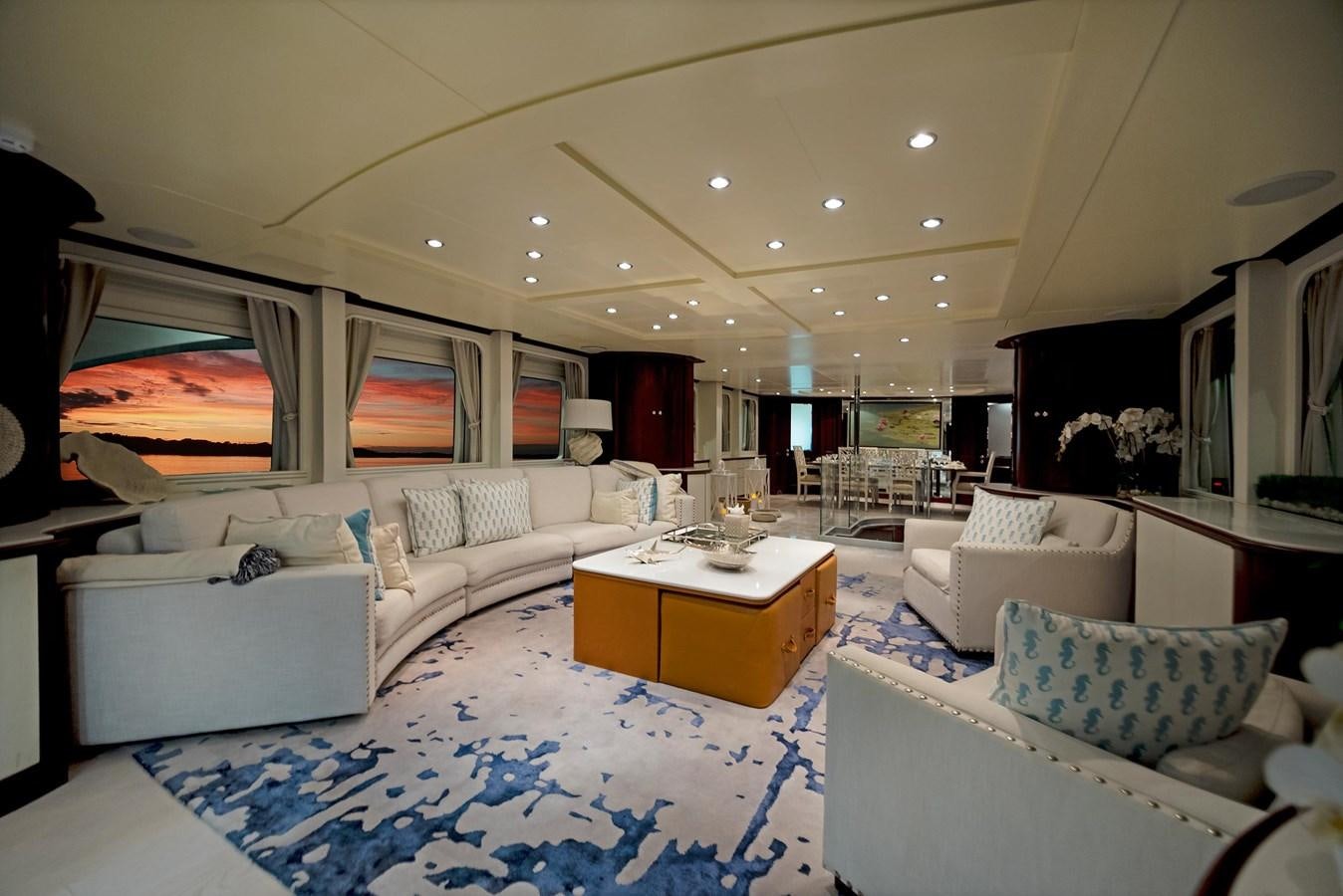a living room with white couches aboard FORTIS Yacht for Sale