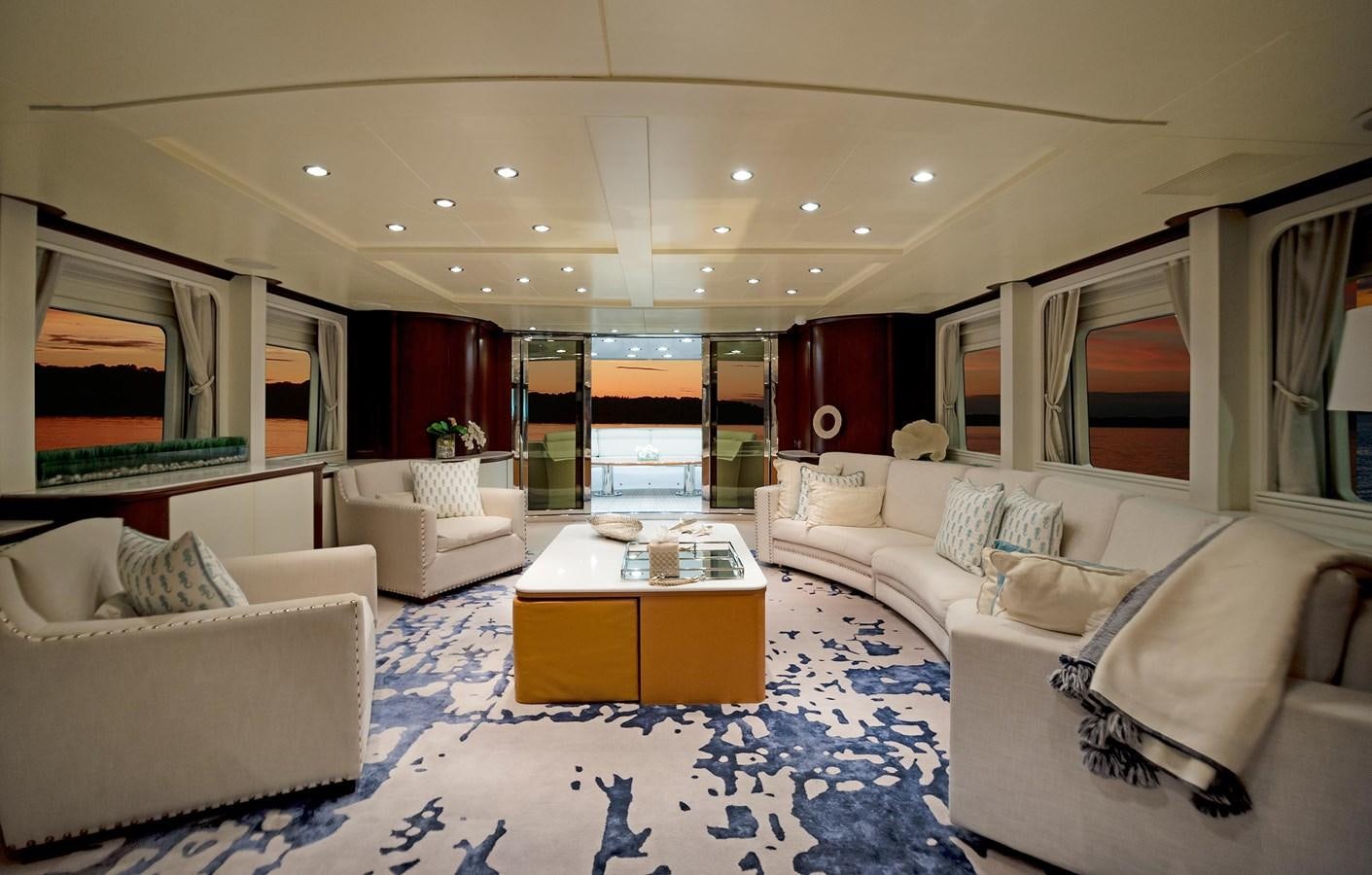a living room with white couches aboard FORTIS Yacht for Sale