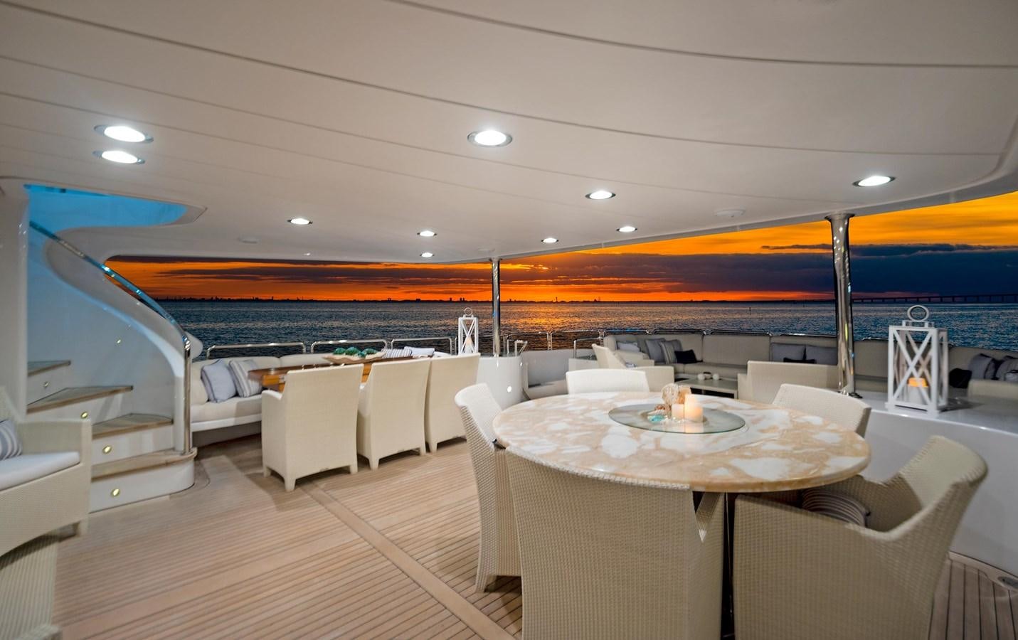 a large room with a table and chairs aboard FORTIS Yacht for Sale