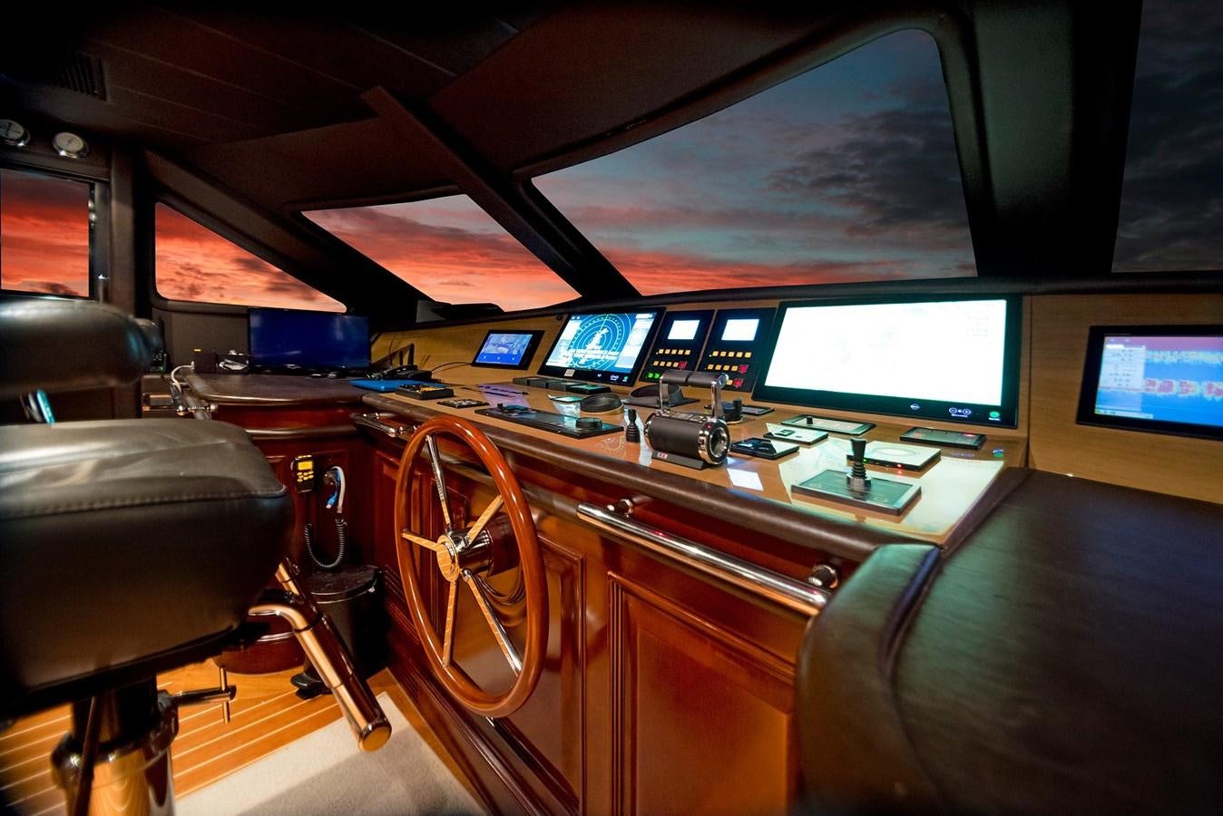 a control room with a large screen aboard FORTIS Yacht for Sale