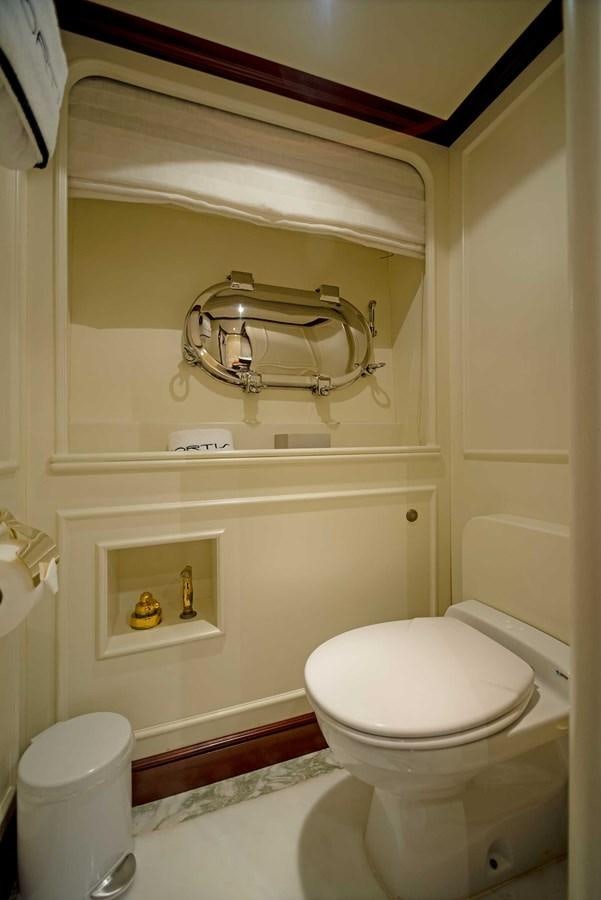 a bathroom with a toilet and a sink aboard FORTIS Yacht for Sale