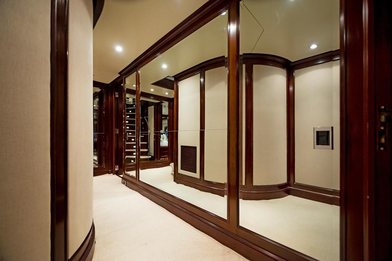 a hallway with glass doors aboard FORTIS Yacht for Sale