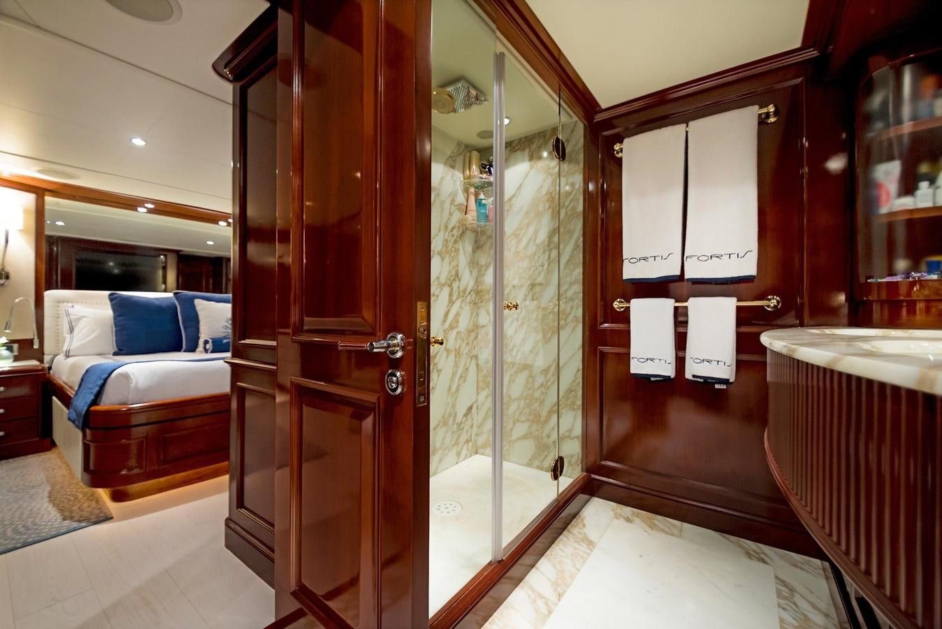 a bathroom with a glass shower aboard FORTIS Yacht for Sale