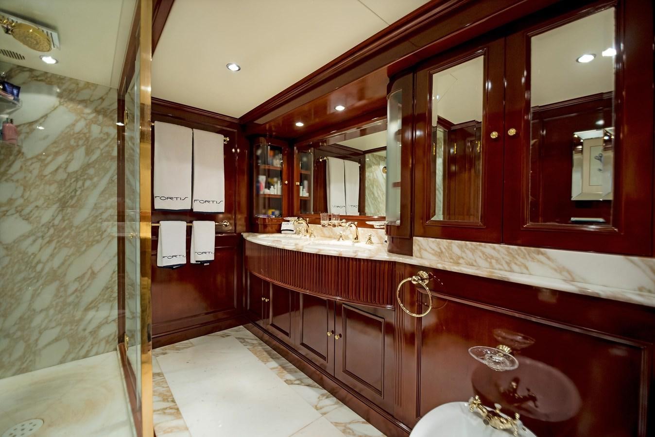 a bathroom with a large mirror aboard FORTIS Yacht for Sale