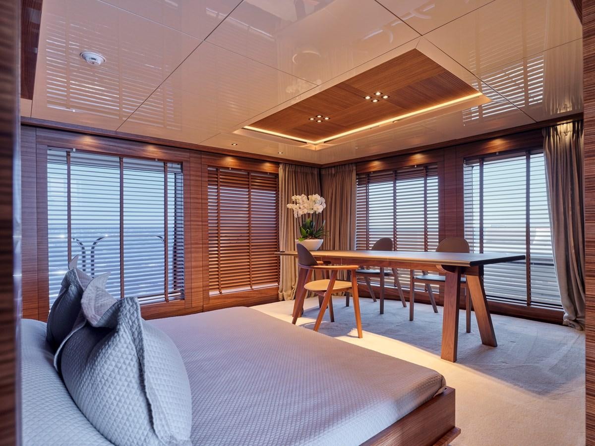 a bed and a table in a room aboard MAGNA GRECIA Yacht for Sale