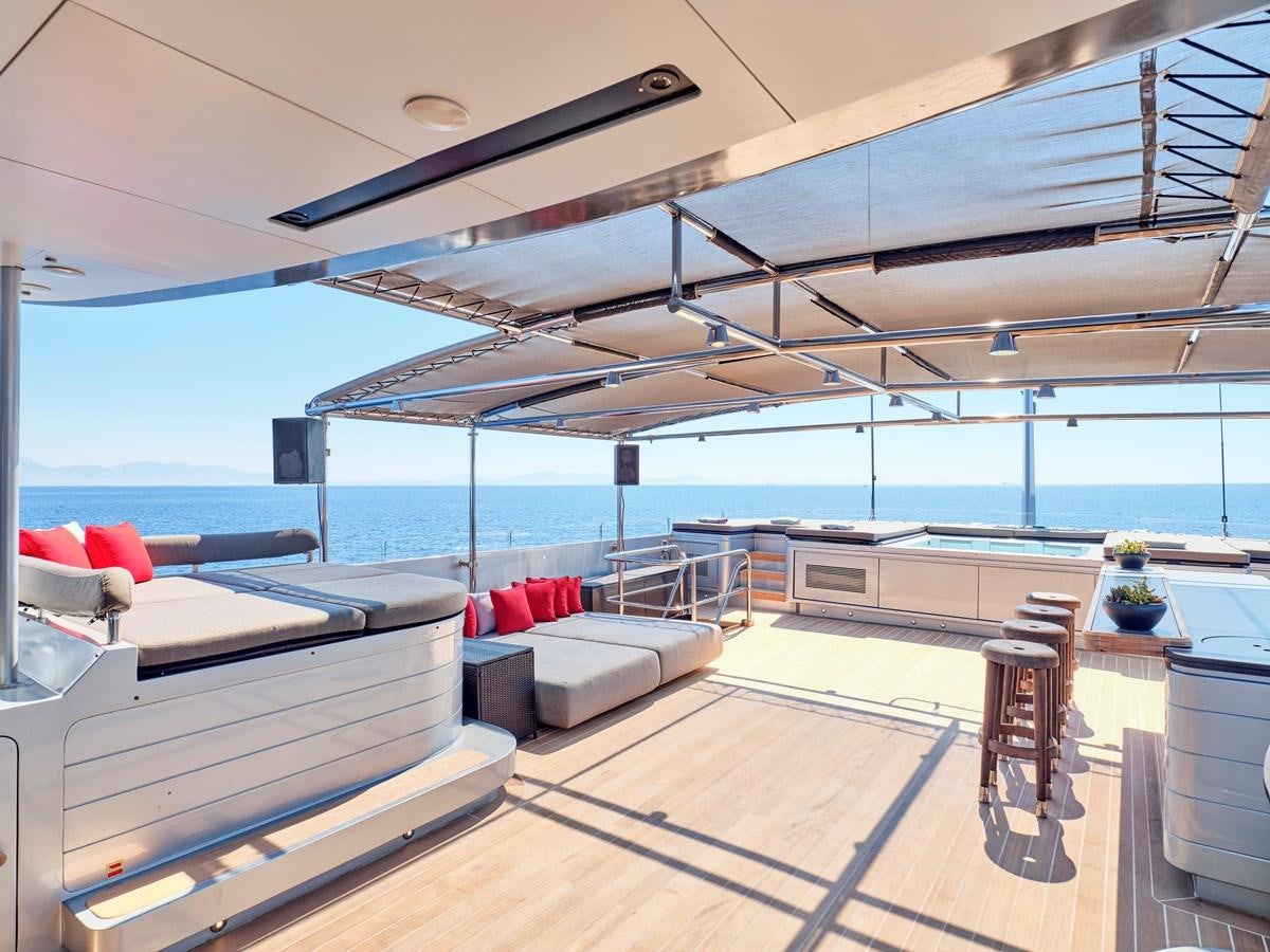 a room with a couch and a table and a pool aboard MAGNA GRECIA Yacht for Sale