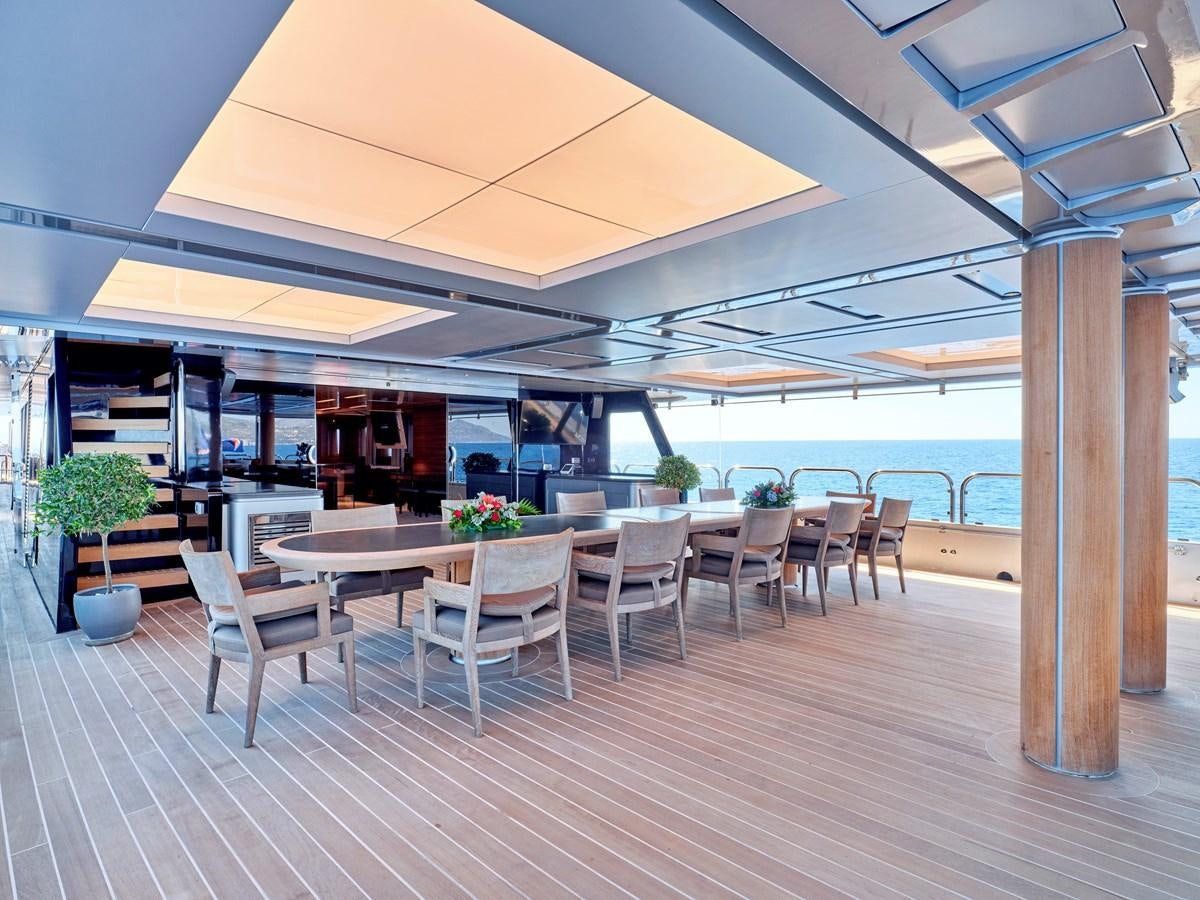a room with tables and chairs aboard MAGNA GRECIA Yacht for Sale