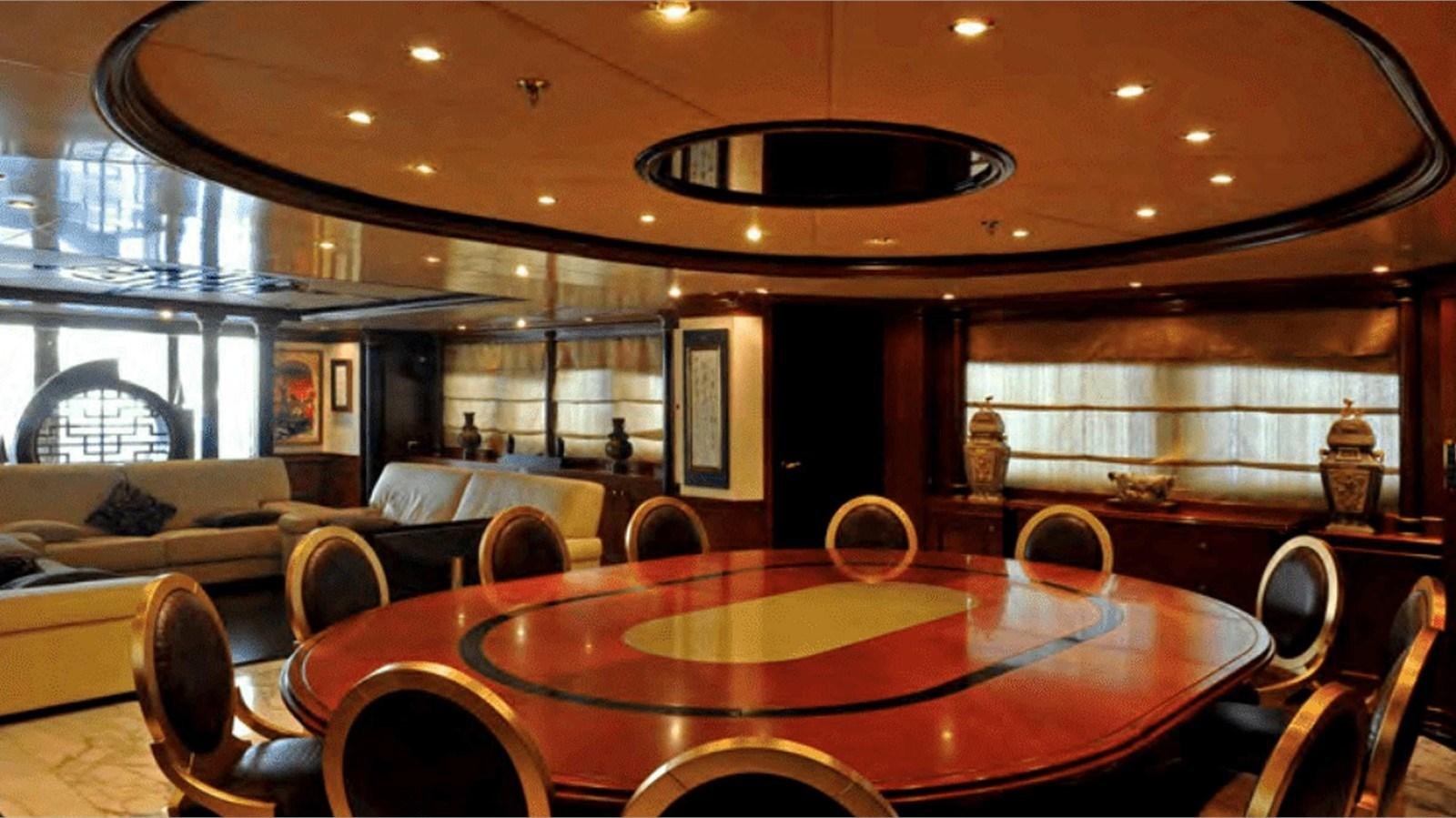 a large room with a pool table and chairs aboard MOZA Yacht for Sale