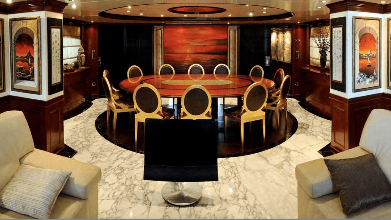 a living room with a table and chairs aboard MOZA Yacht for Sale