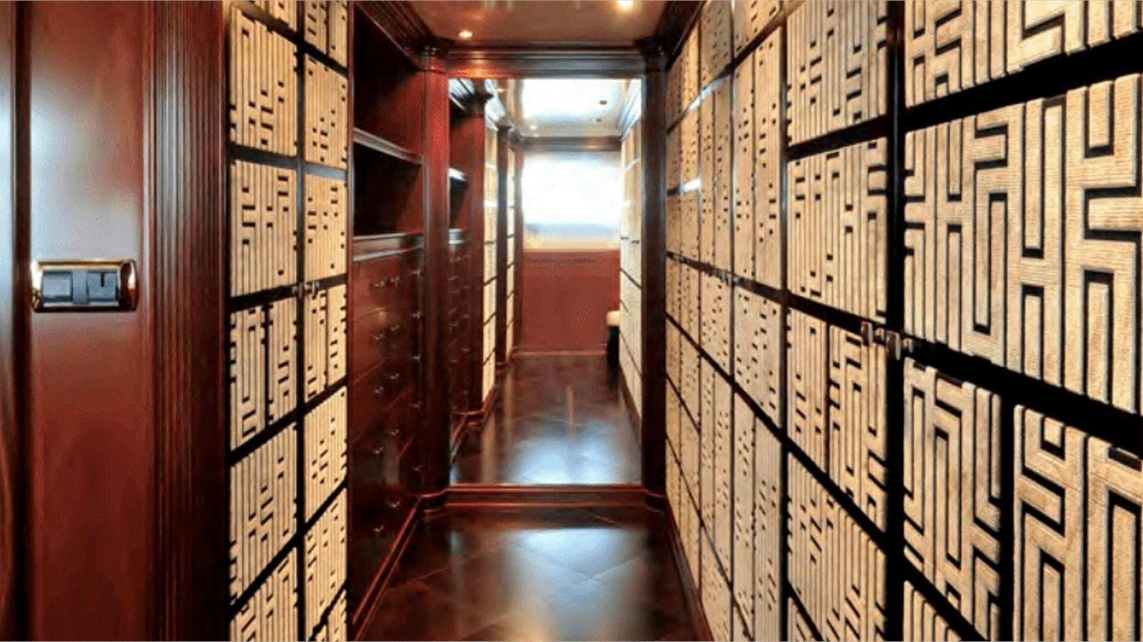 a hallway with many bookshelves aboard MOZA Yacht for Sale