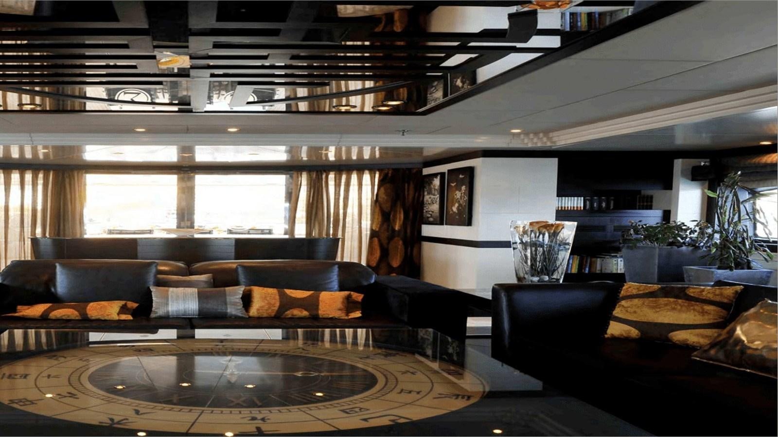 a room with leather couches and a large window aboard MOZA Yacht for Sale