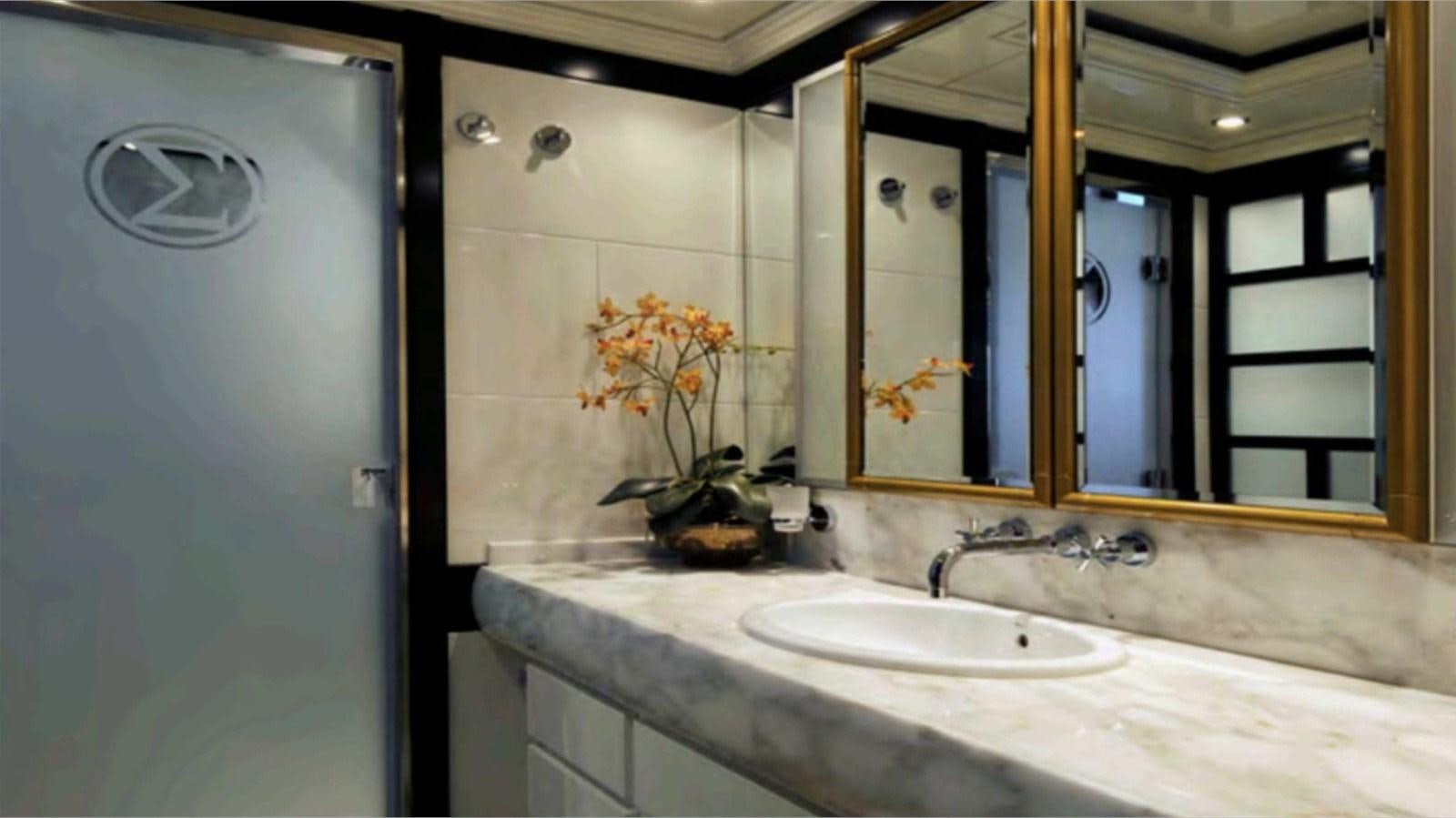 a bathroom with a sink and mirror aboard MOZA Yacht for Sale