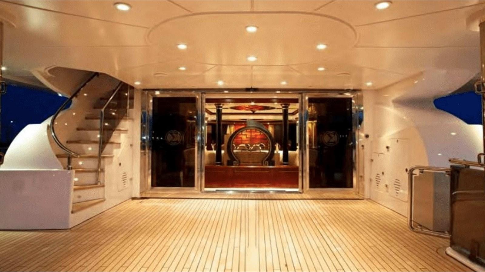 a large room with a staircase and glass doors aboard MOZA Yacht for Sale