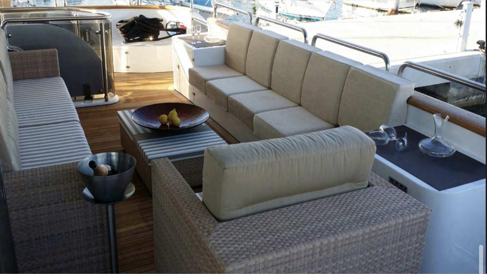 a couch and a table in a room aboard MOZA Yacht for Sale