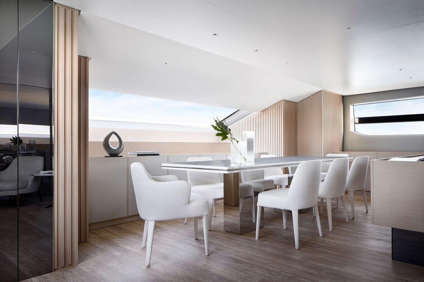 a room with a table and chairs aboard COOL Yacht for Sale