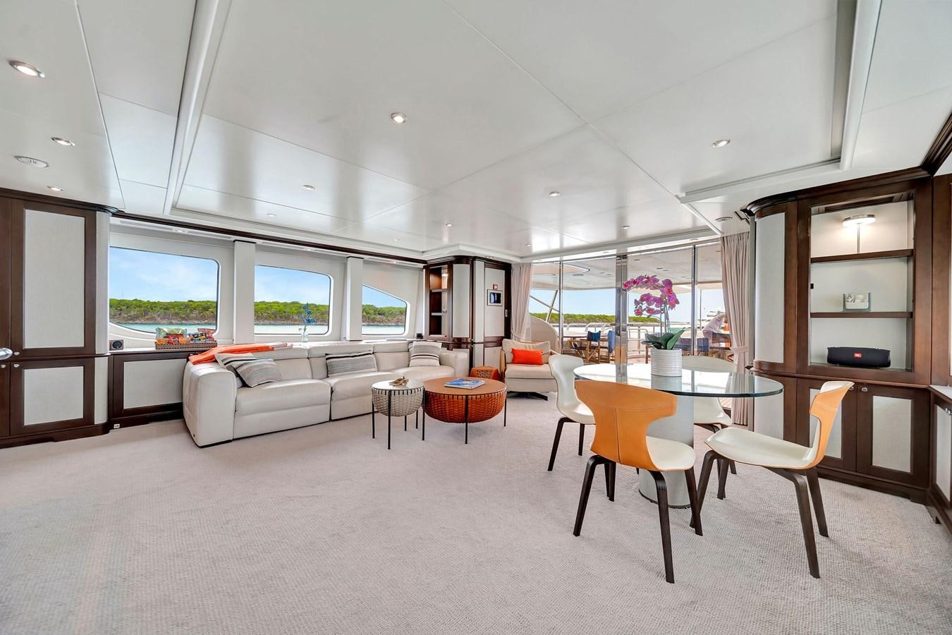 a living room with a white couch and a table aboard PAPAITO Yacht for Sale