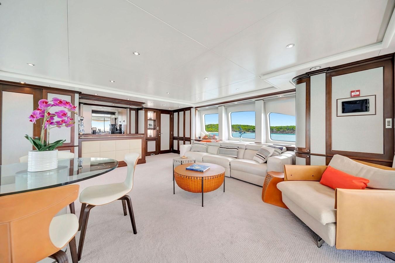 a living room with a table and chairs aboard PAPAITO Yacht for Sale
