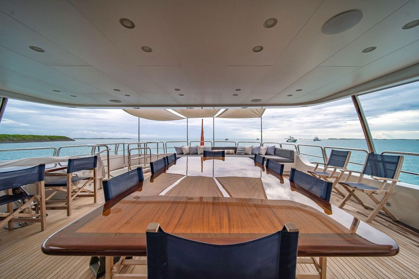 a boat with tables and chairs aboard PAPAITO Yacht for Sale