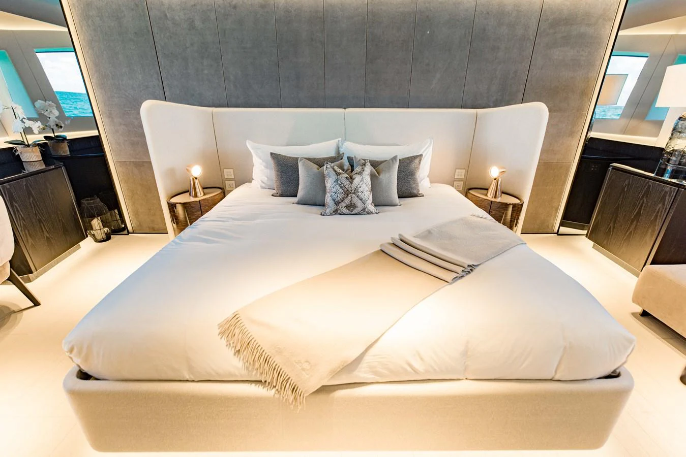 a large bed with white sheets aboard OFFLINE Yacht for Sale
